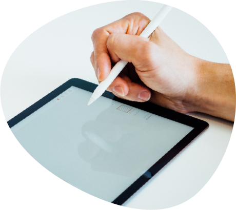 Person holding stylus on tablet